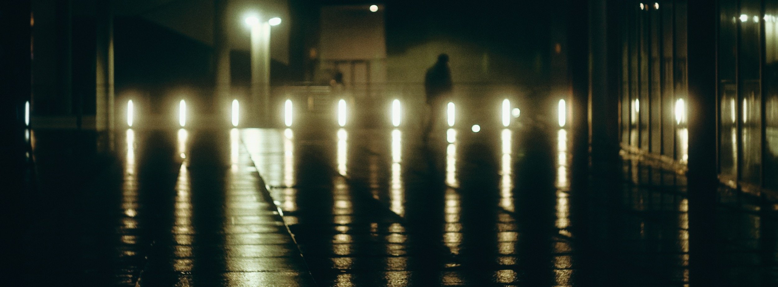 Street photograph, Bilbao, 2025. 65×24 wide panoramic format.