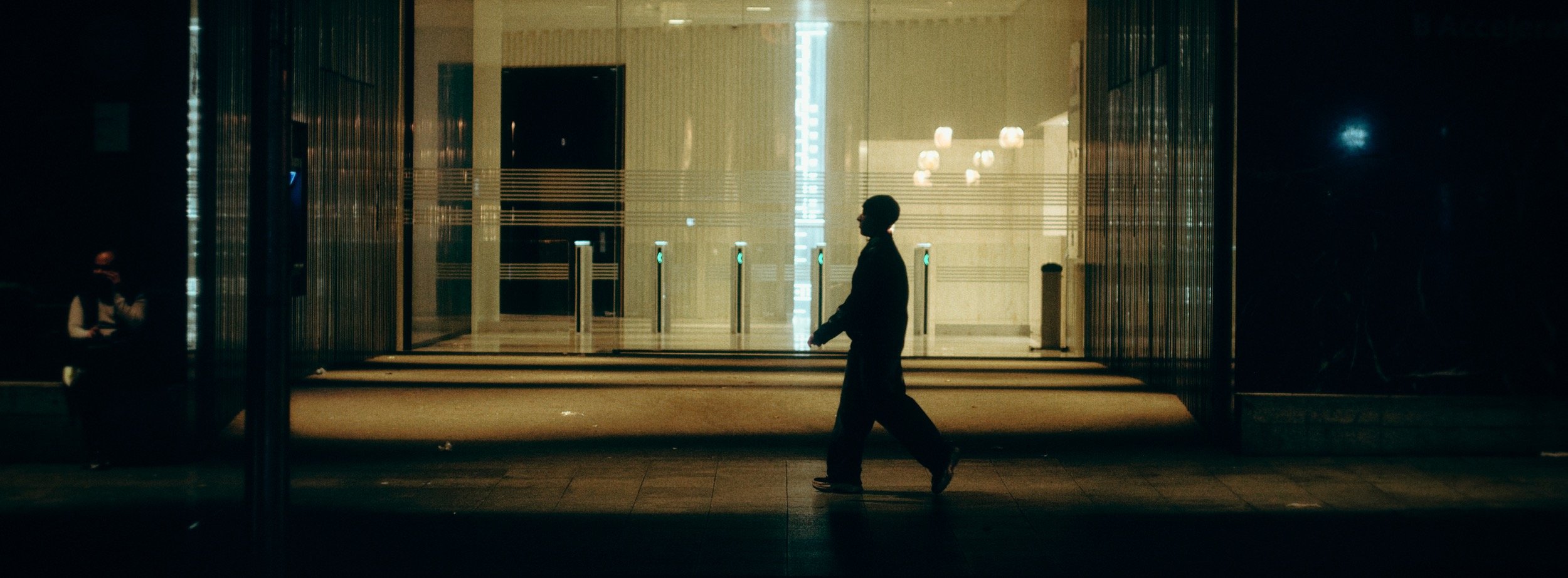 Street photograph, Bilbao, 2025. 65×24 wide panoramic format.
