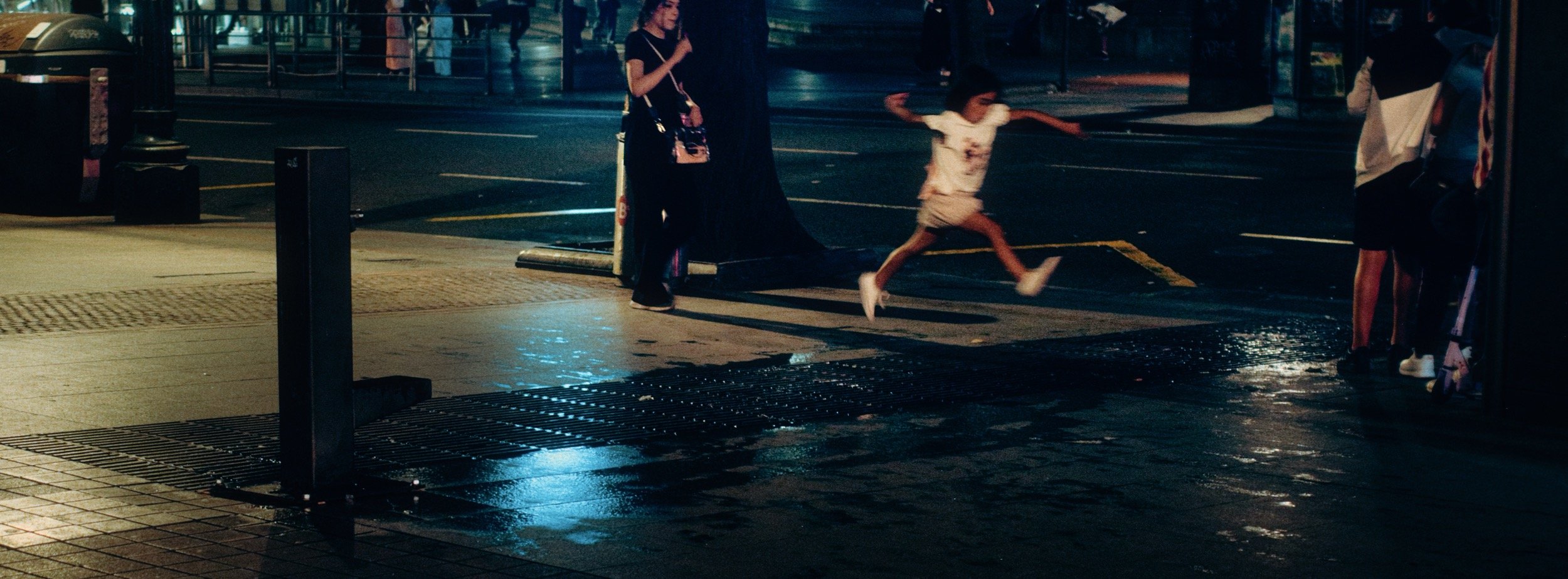 Street photograph, Bilbao, 2025. 65×24 wide panoramic format.