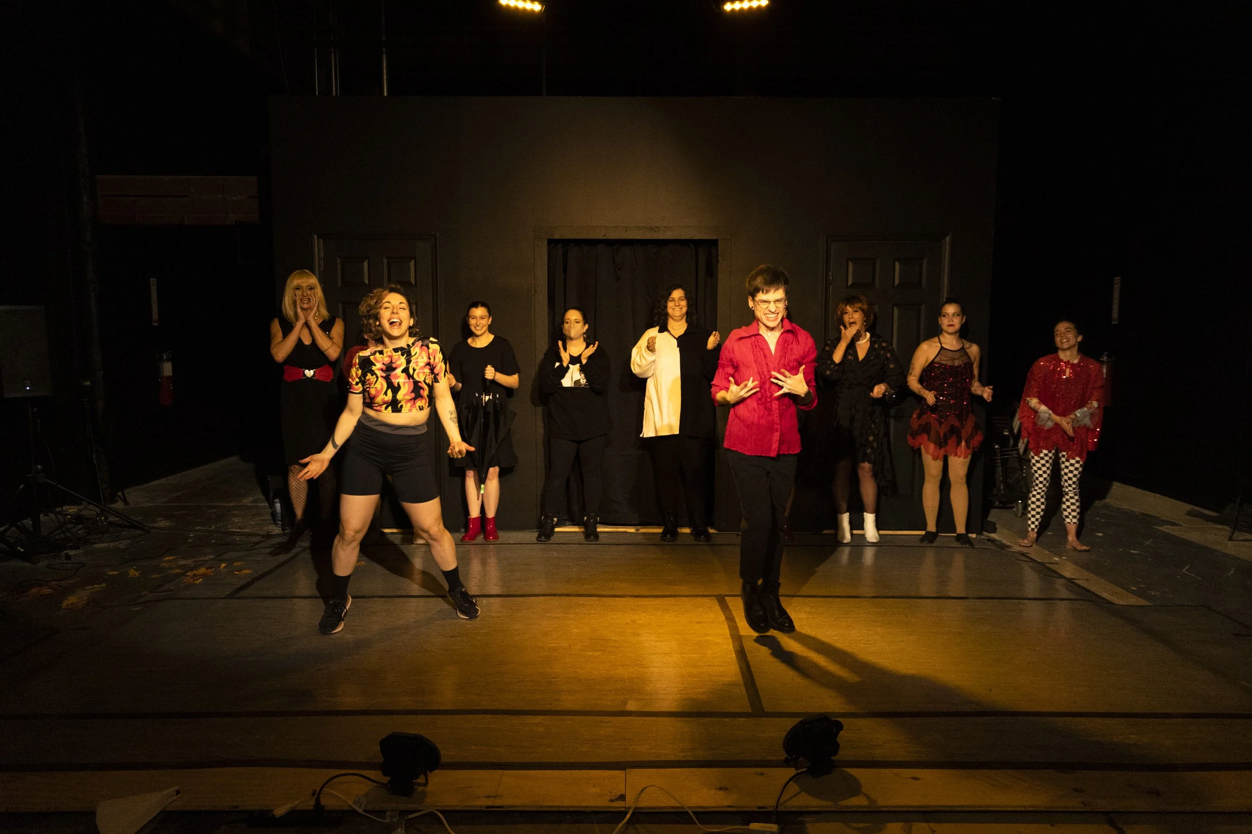 Dancers line up for the finale at the first ever annual RECITAL. Alyssa and Chris stand in front of the cast, smiling.