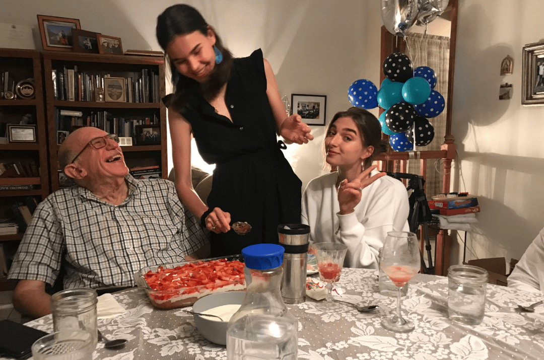 Lolo smiling at Carolina McCabe and sitting with Sofia Hidalgo inside of their home in Miami, Florida.