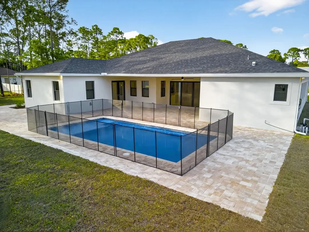 New-construction home with fenced pool