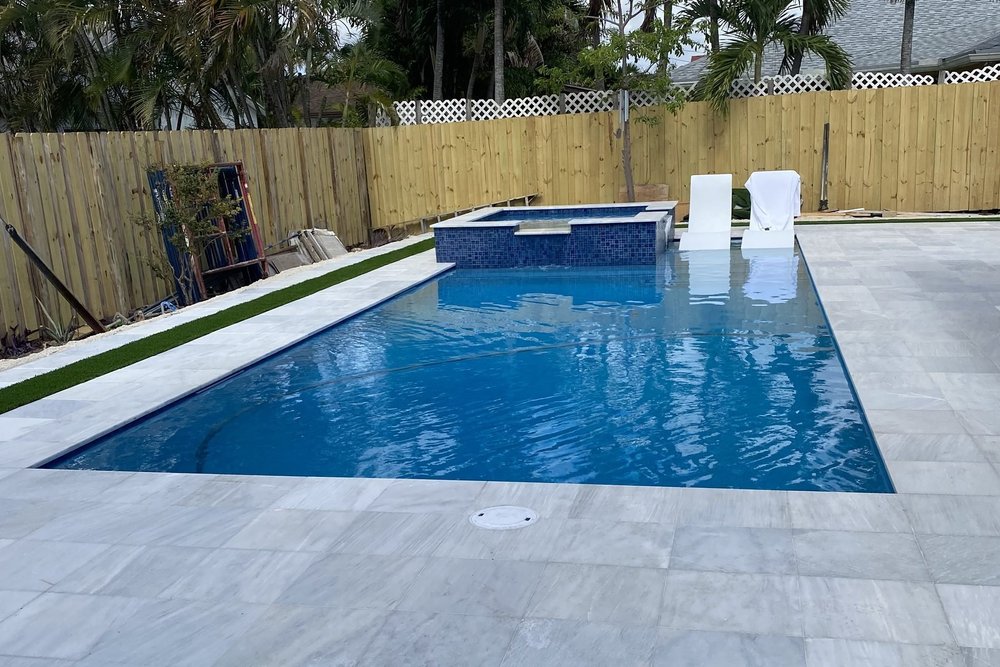 Long pool with raised spa and white deck