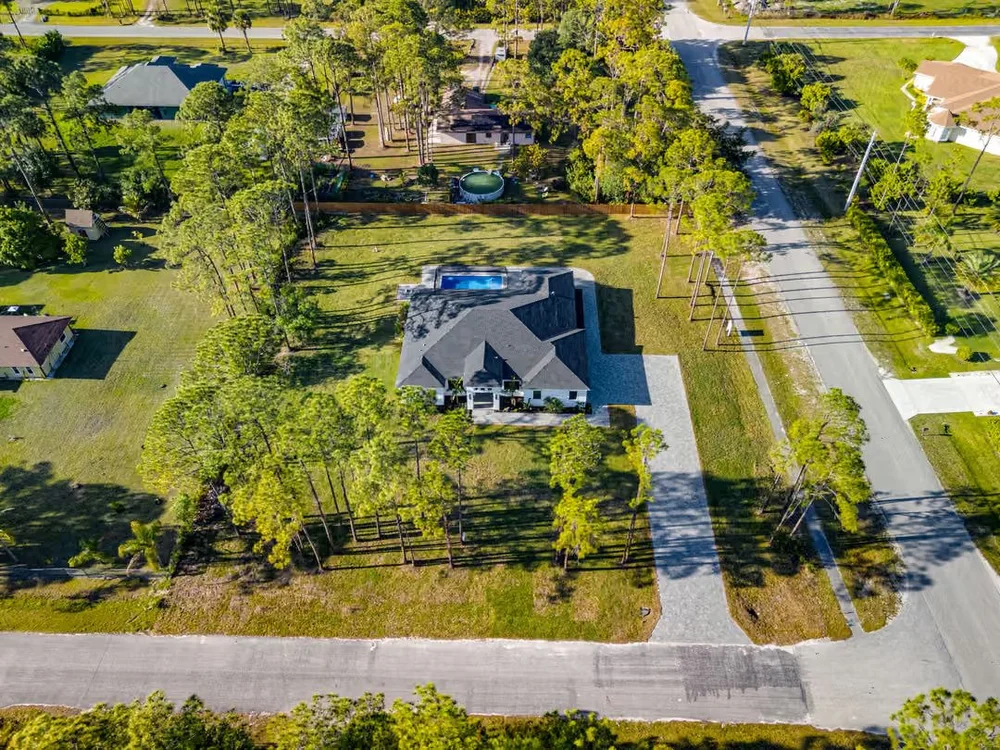 Aerial view of a new-construction home with pool