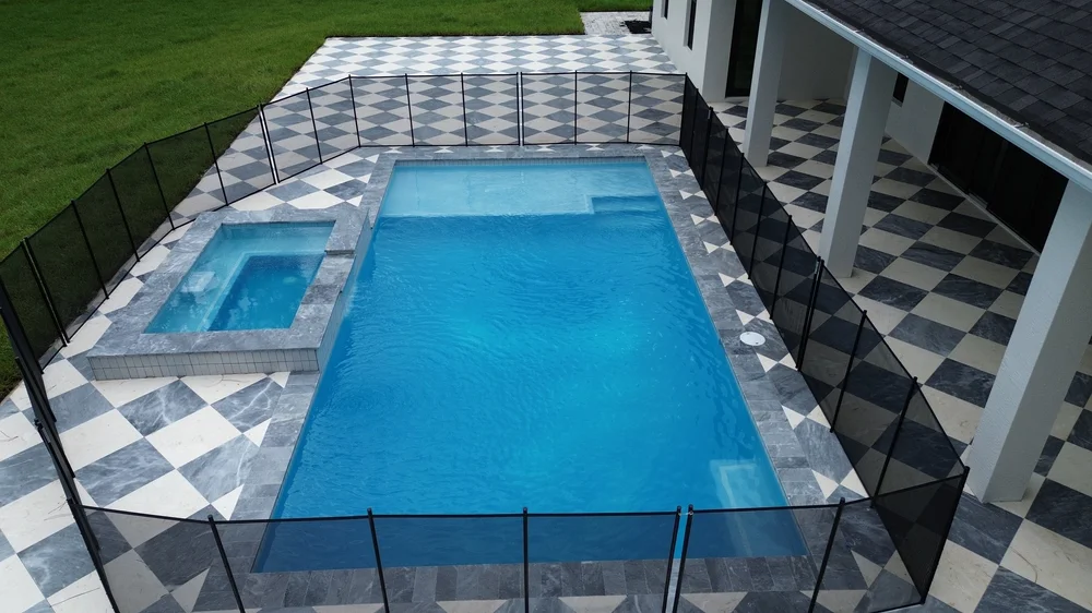 Aerial view of a new pool and spa with checkered deck