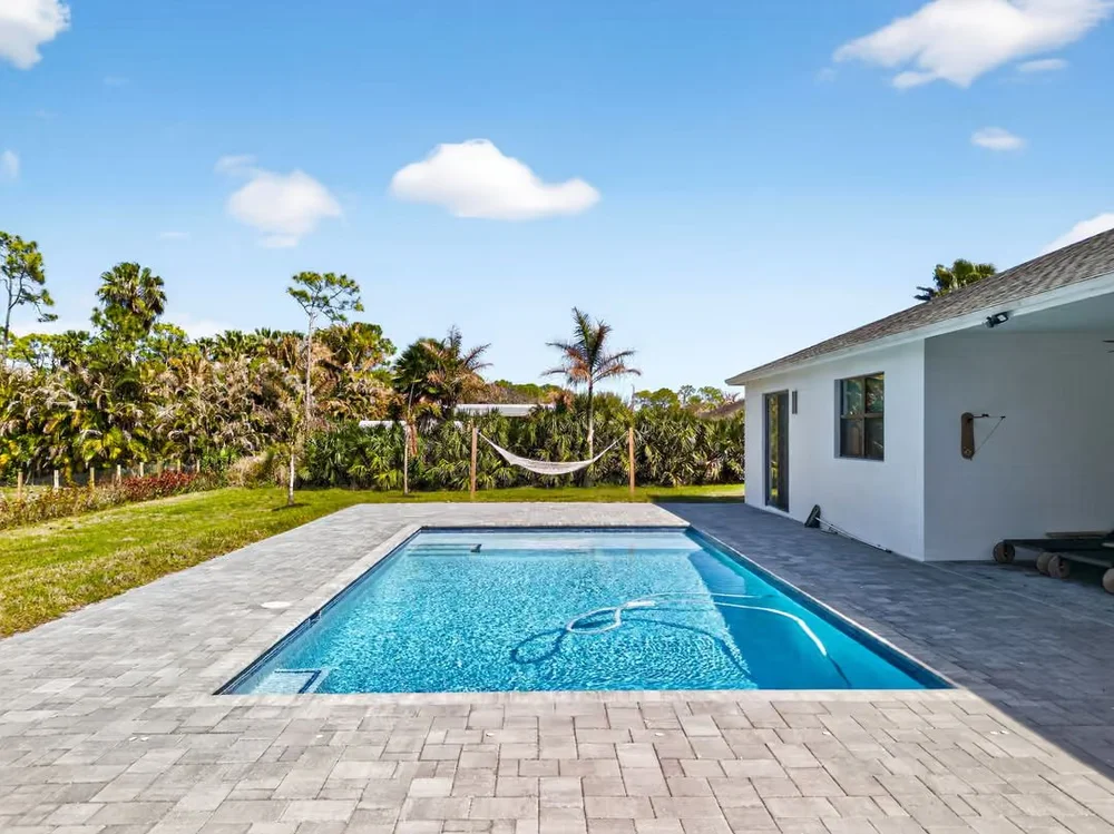 New-construction home with fenced pool