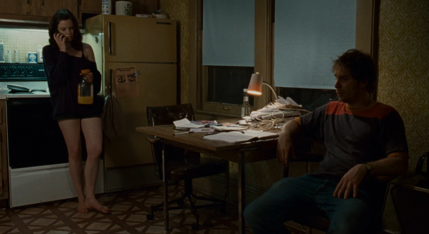 Gillian Jacobs and Sam Rockwell hang out in a kitchen in the movie Choke (2008)