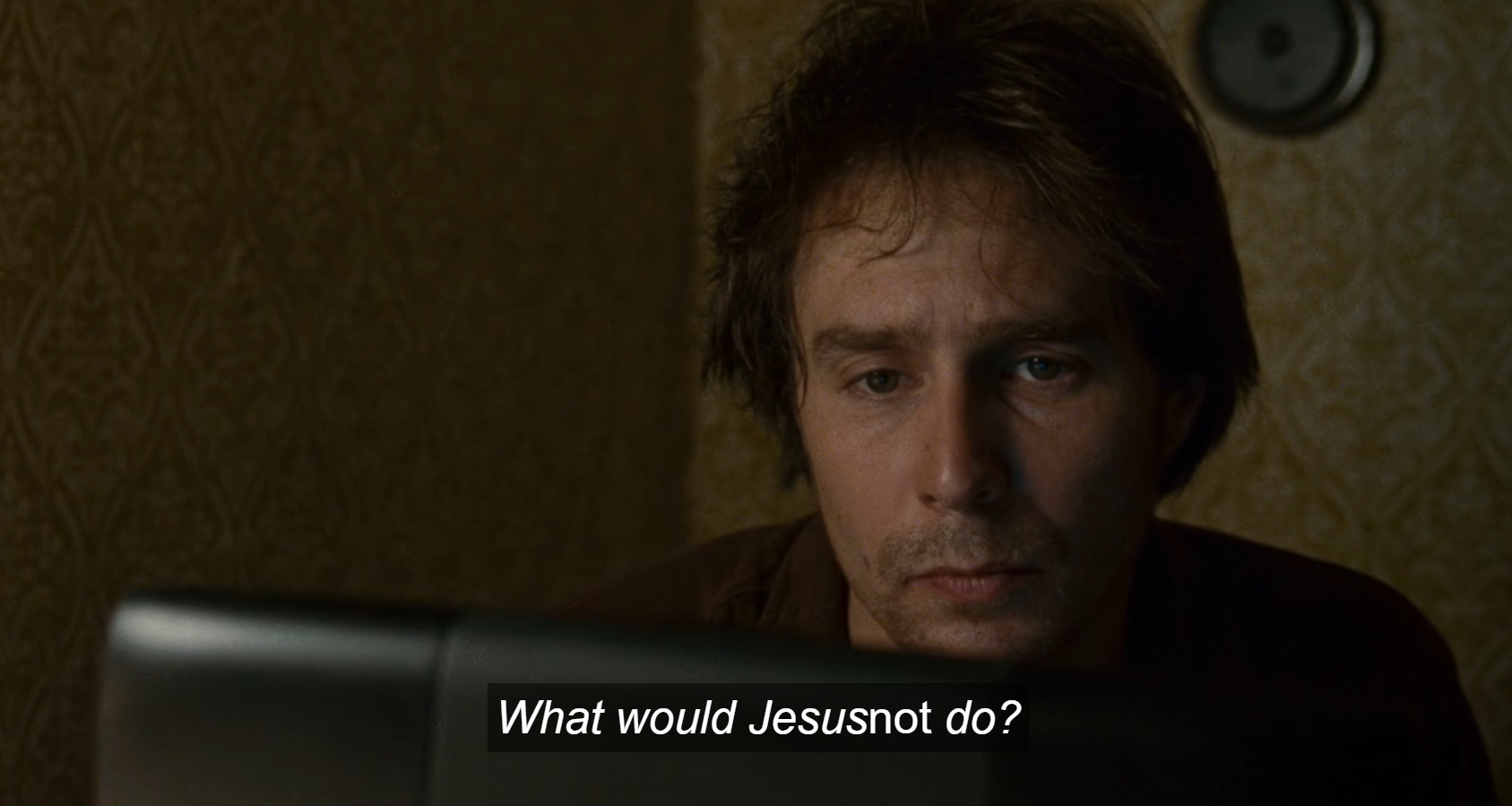 Sam Rockwell looking at a computer screen with disheveled hair, a bit forlorn. The caption reads "what would Jesus NOT do?"