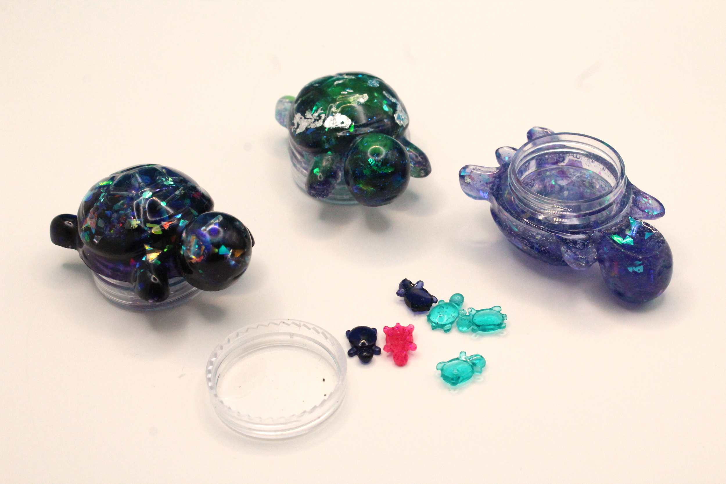container turtles, with one on its back and babies spilled out