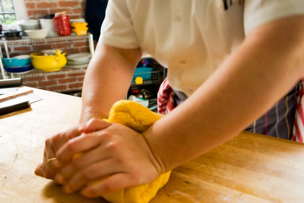 Isabella kneading pasta dough.