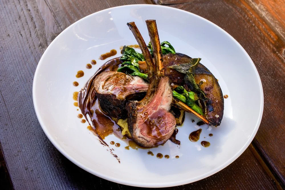 Lamb Chops with 85% Chocolate-Lamb Sauce, Chestnut Polenta, Winter Squash, and Bitter Greens. 