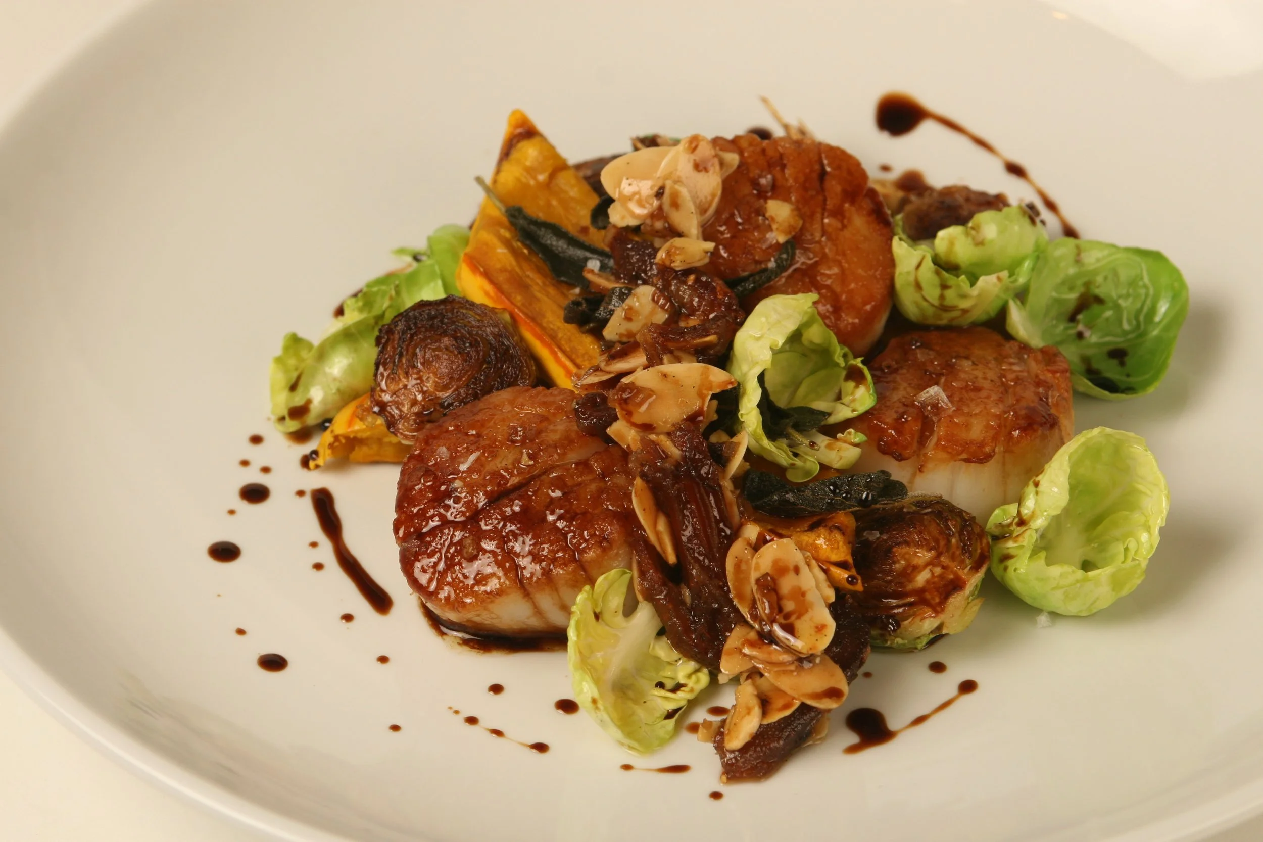 Seared Scallops with Delicata Squash, Brussels Sprouts, Almond and Date Relish, and Balsamico Tradizionale. 