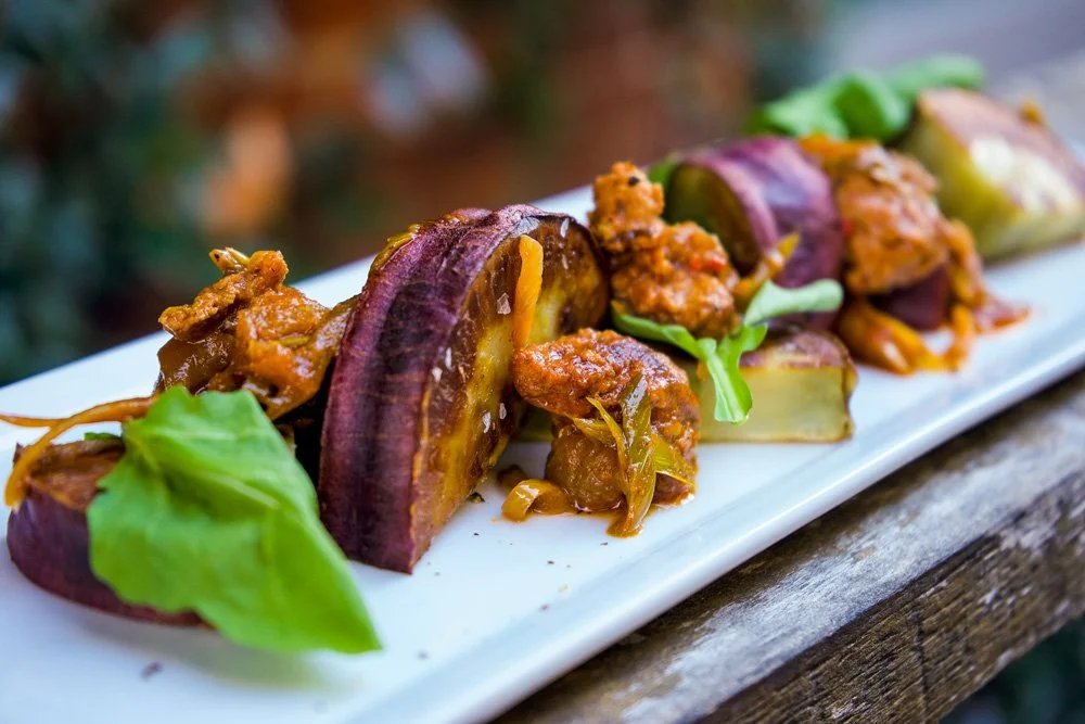 Roasted Murasaki Sweet Potato, Calabrian Sausage, Long-Cooked Scallions, and Arugula. 