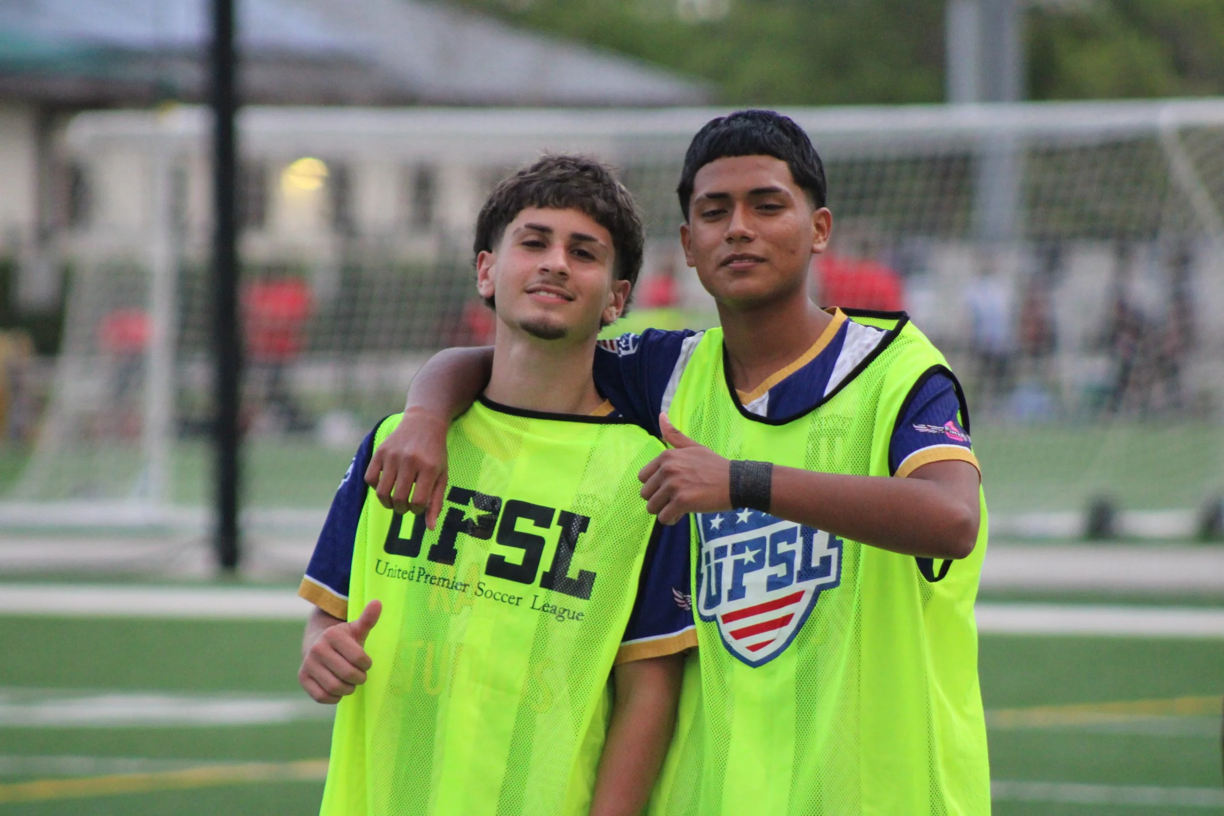 Two of our young players in development, showing sportsmanship and growth on the pitch.
