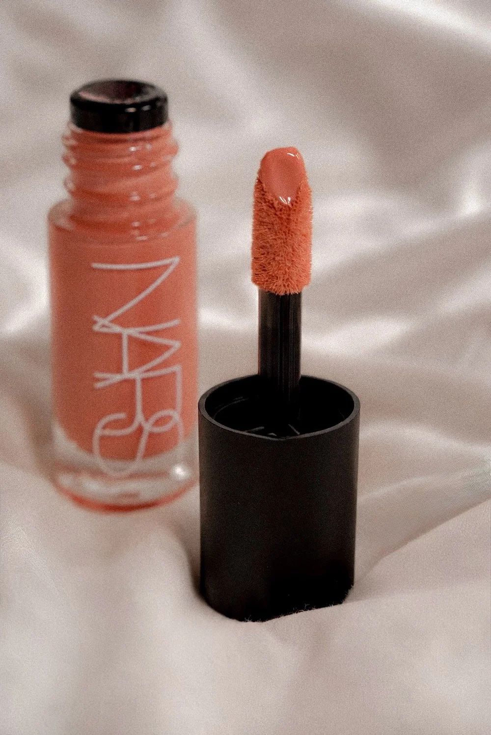 Editorial beauty photograph featuring a NARS lip product