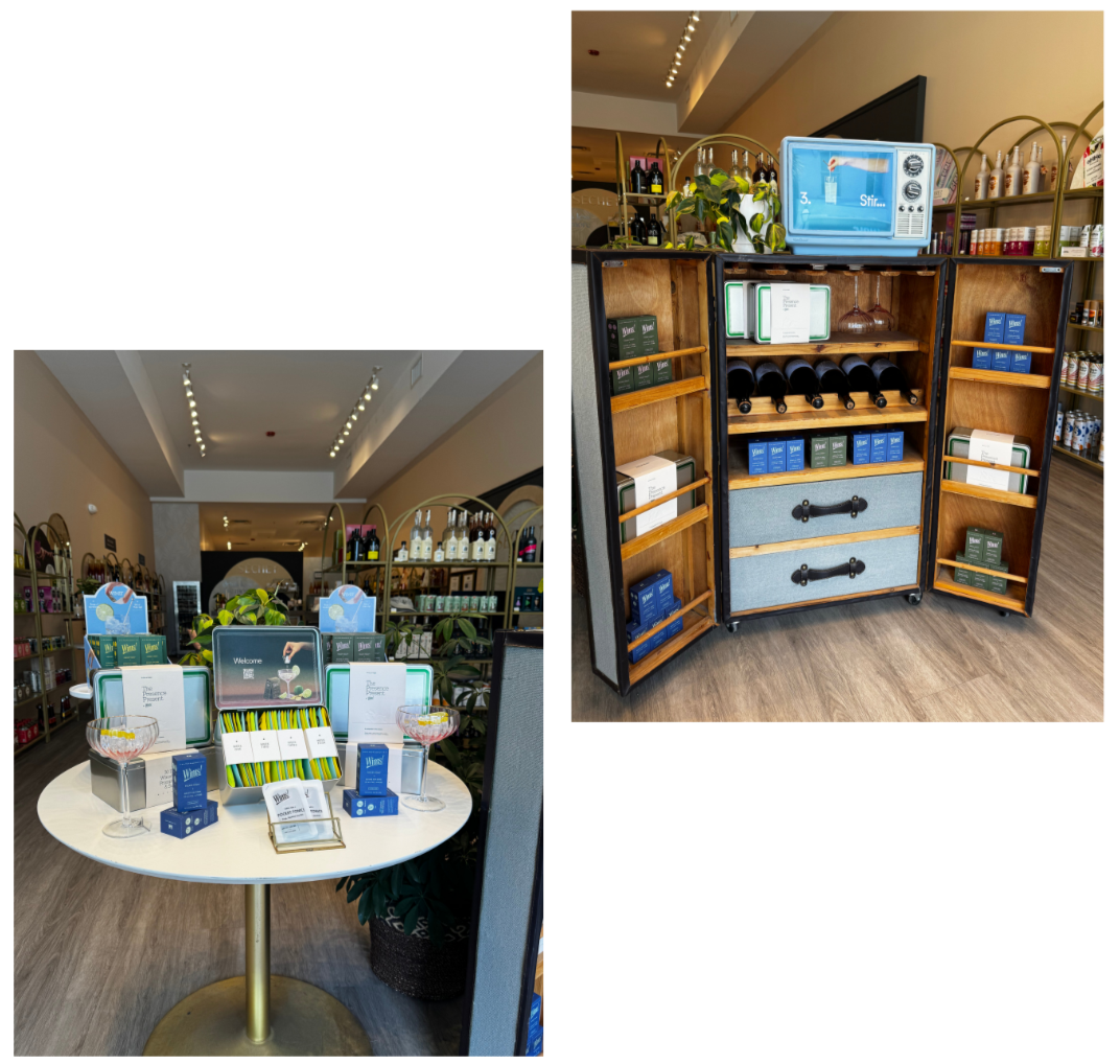 Display of skincare or wellness products arranged on a round table and wooden shelves in a retail store.