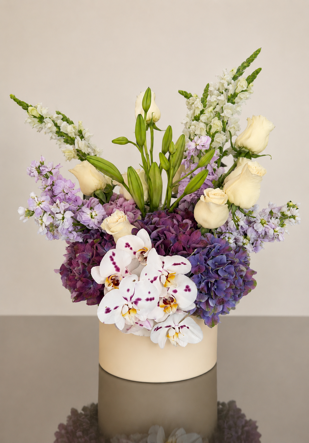 Elegant floral centerpiece with orchids and hydrangeas designed by luxury florist Stem & Vine Studio.