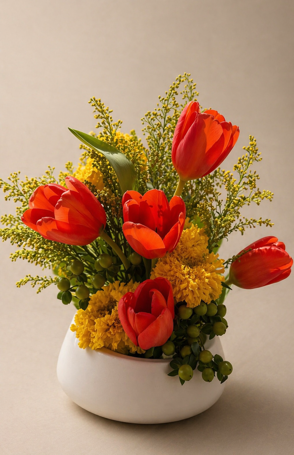 Contemporary floral centerpiece with tulips, seasonal blooms, and layered greenery designed for refined interiors and upscale 
gifting.