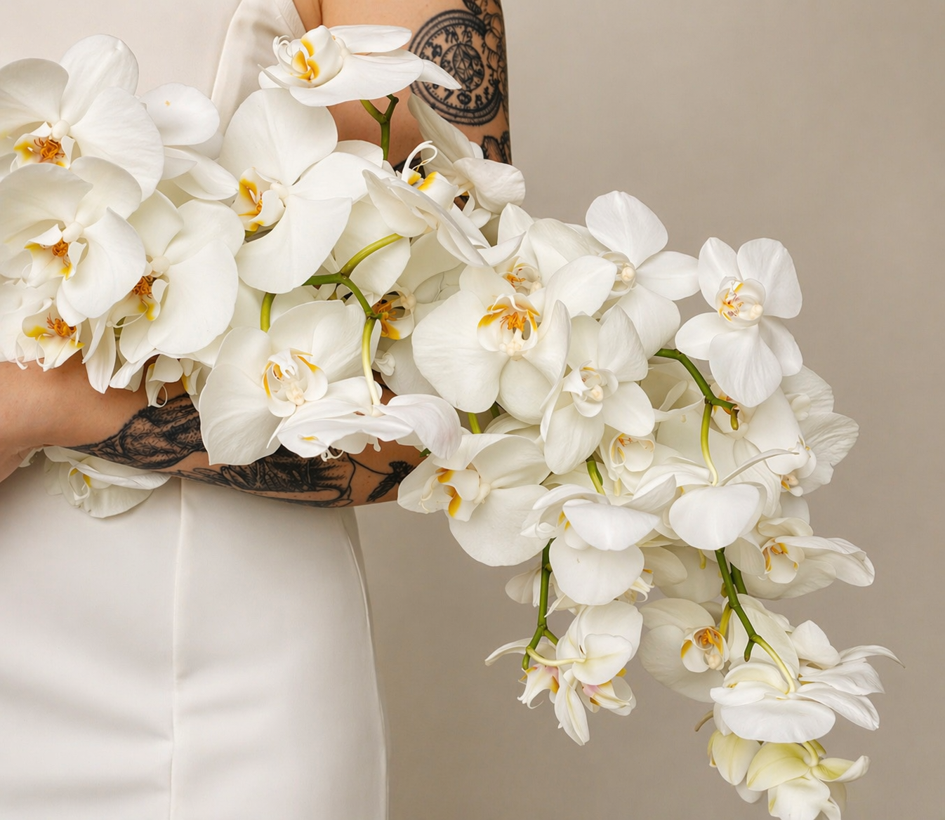 Cascading white orchid bridal bouquet with an editorial, luxury-inspired silhouette by Stem & Vin Studio.