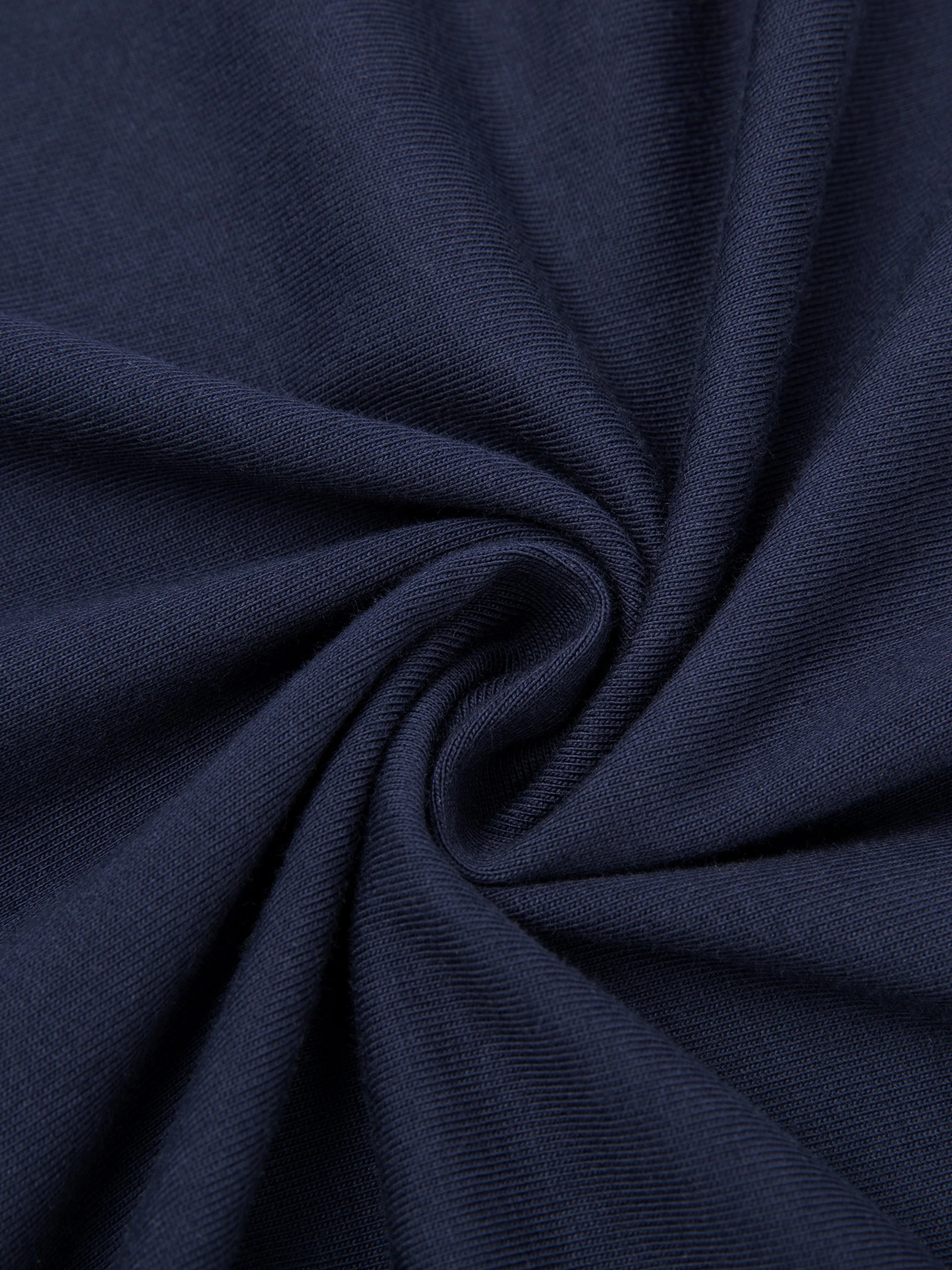 Close-up of dark blue fabric with a smooth, woven texture, gathered in a spiral pattern.