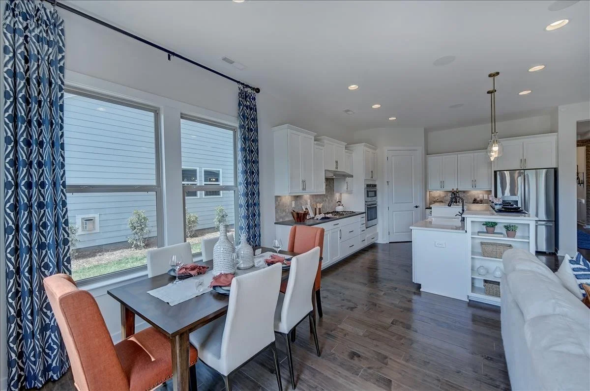 pinnacle-at-wesley-chapel-dining-area-and-kitchen-with-large-windows-active-adult-community-wesley-chapel-nc.jpg