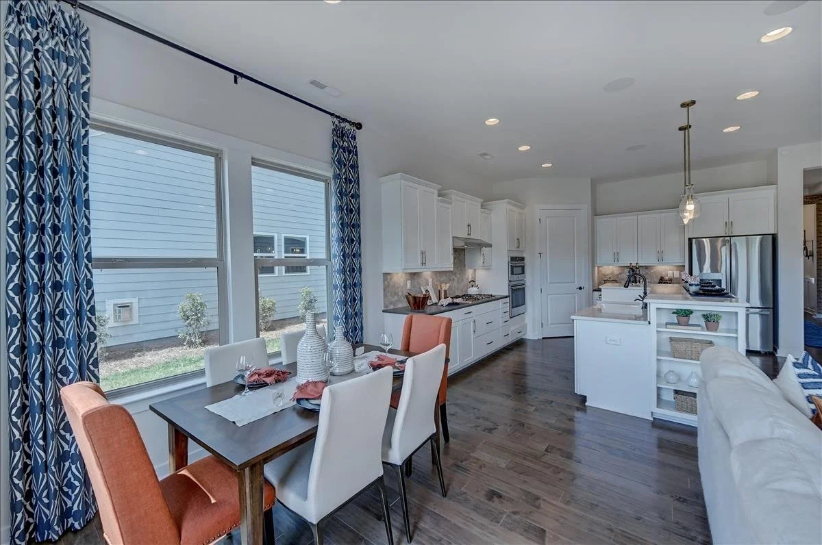 pinnacle-at-wesley-chapel-dining-area-and-kitchen-with-large-windows-active-adult-community-wesley-chapel-nc.jpg
