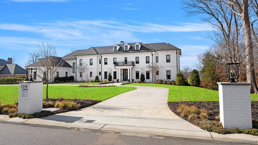 large-white-modern-colonial-home-with-circular-driveway-and-gated-entrance.jpg
