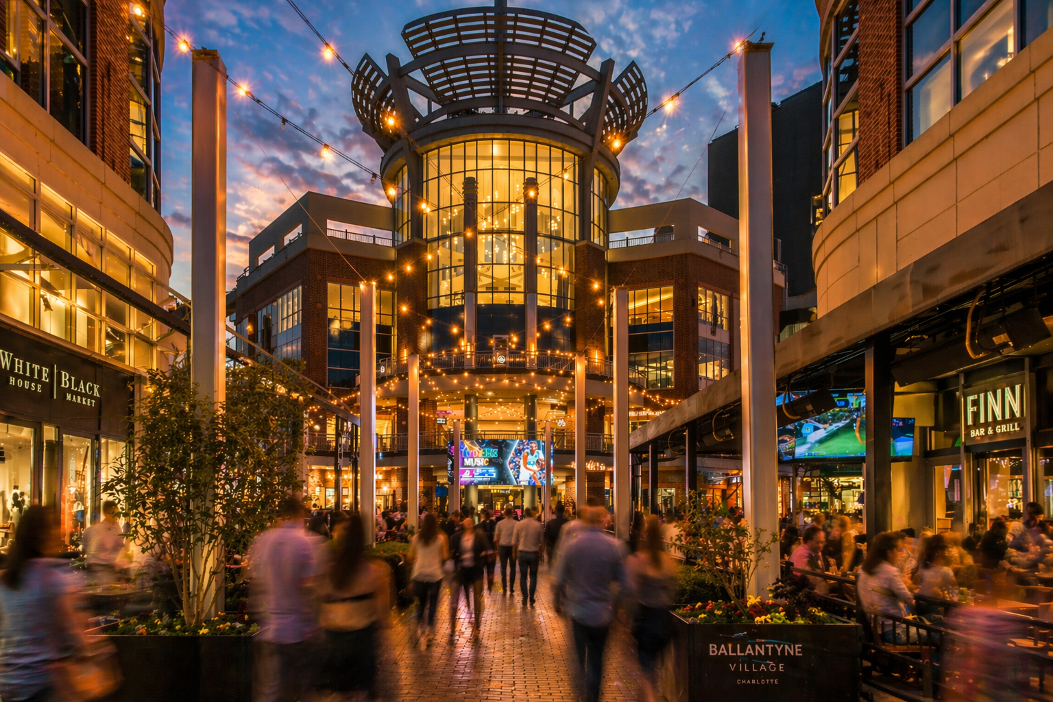 ballantyne-charlotte-nc-outdoor-shopping-district-at-night-with-crowds.png