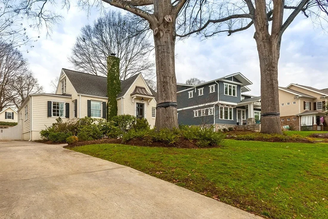 dilworth-charlotte-nc-white-craftsman-home-with-black-shutters-and-mature-trees.webp