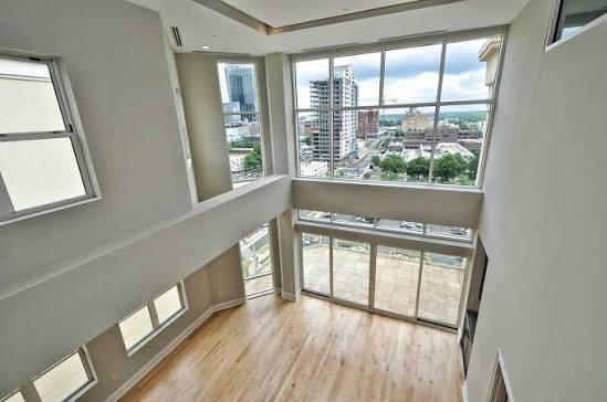 uptown-charlotte-nc-condo-interior-corner-room-with-floor-to-ceiling-city-view-windows.jpeg
