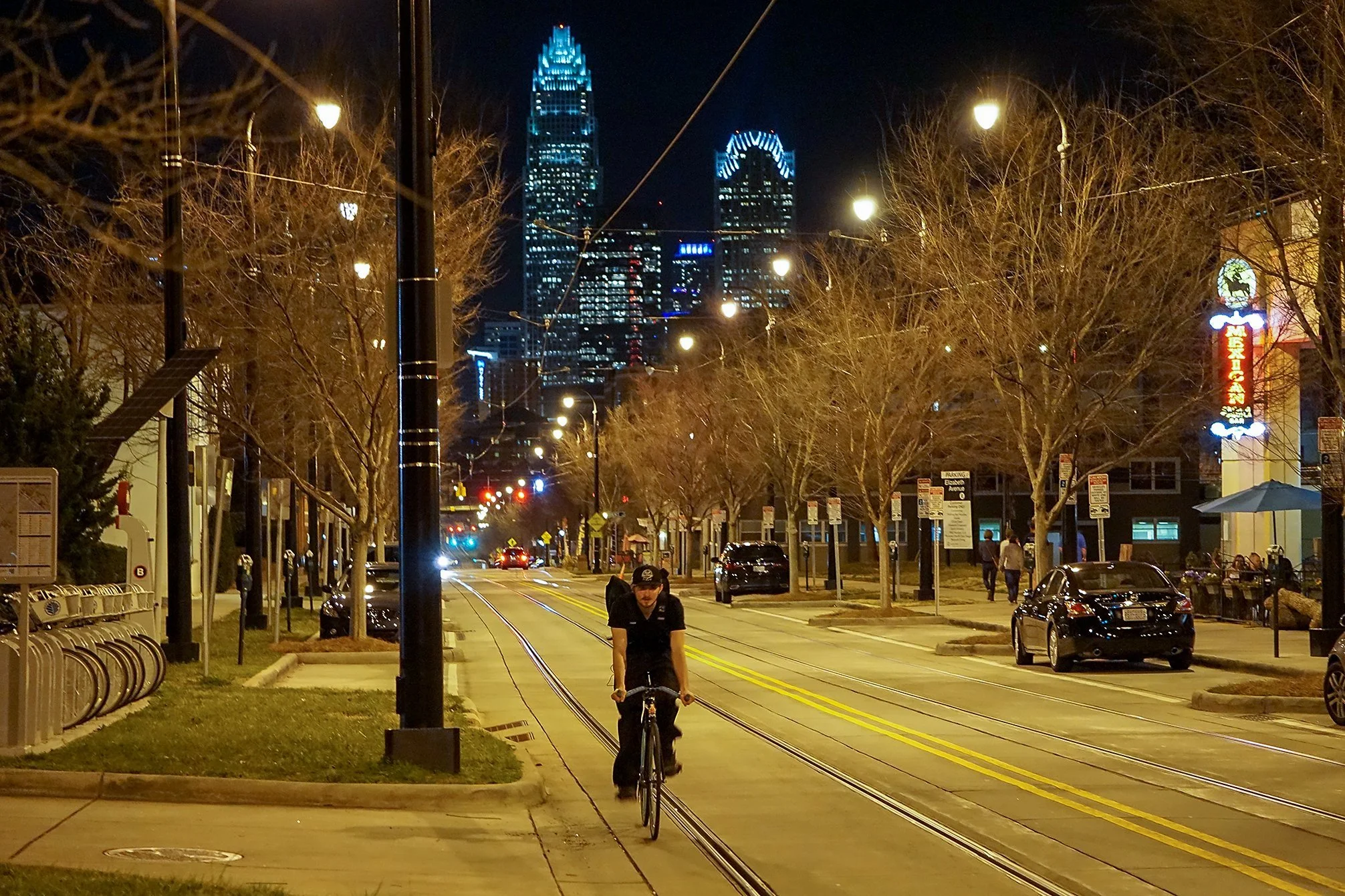 elizabeth-charlotte-nc-central-avenue-at-night-with-cyclist-and-city-lights.jpg