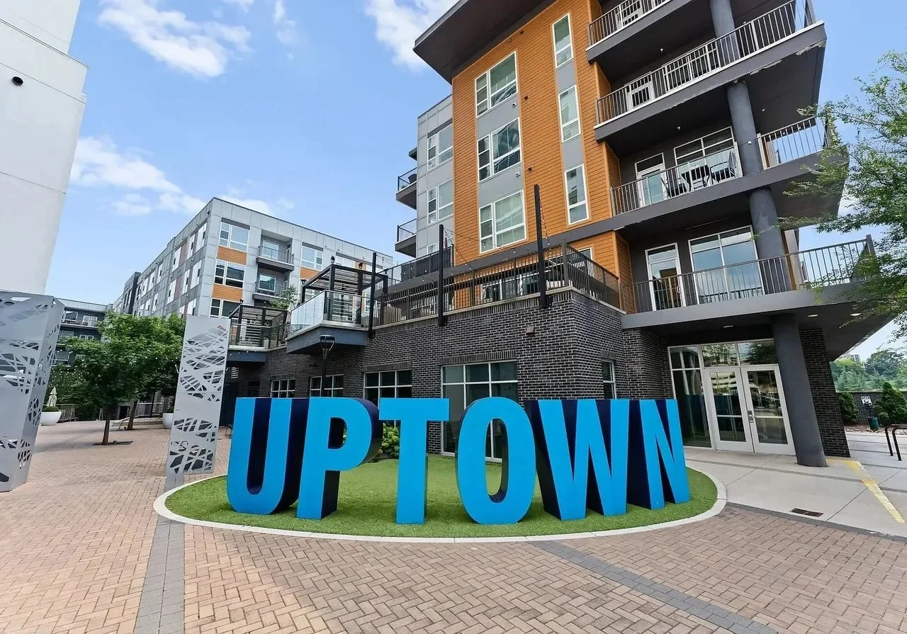 uptown-charlotte-nc-blue-letter-sign-in-front-of-modern-condo-building.webp