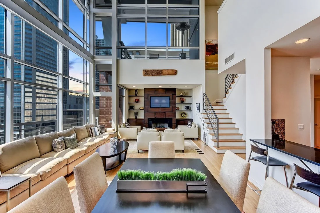 uptown-charlotte-nc-luxury-condo-interior-with-floor-to-ceiling-windows-and-staircase.jpg