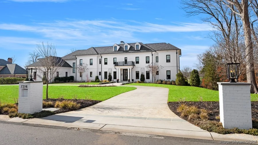 large-white-modern-colonial-home-with-circular-driveway-and-gated-entrance.jpg