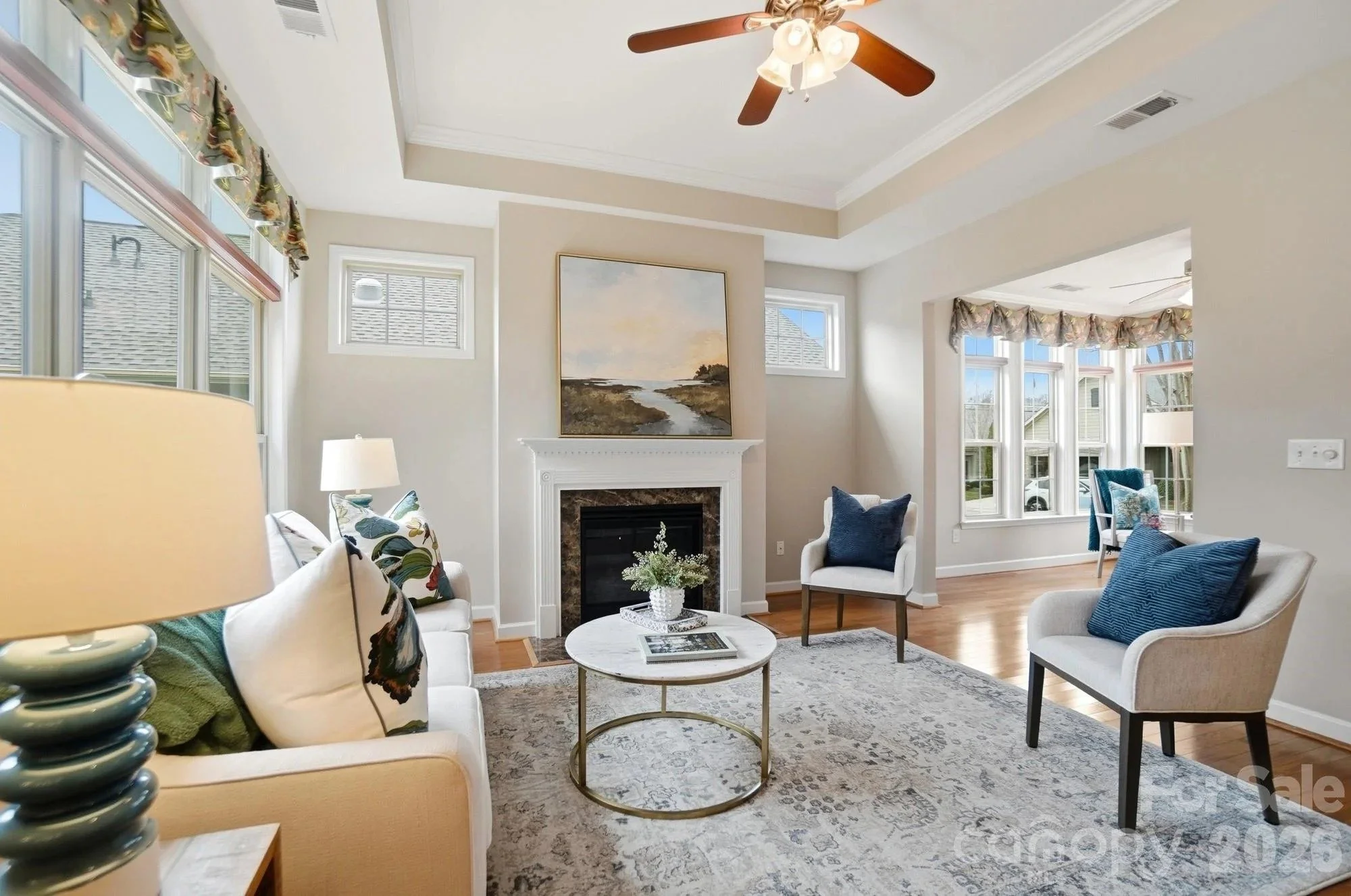 polo-club-at-mountain-island-lake-living-room-with-fireplace-and-blue-accent-chairs-active-adult-community-charlotte-nc.jpg