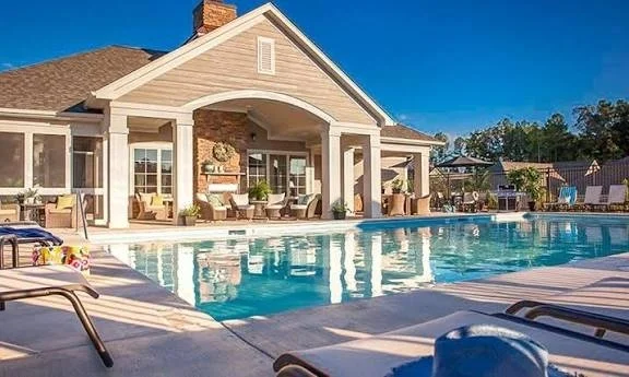 the-courtyards-at-lake-davidson-clubhouse-exterior-and-pool-with-lounge-chairs-active-adult-community-davidson-nc.jpg