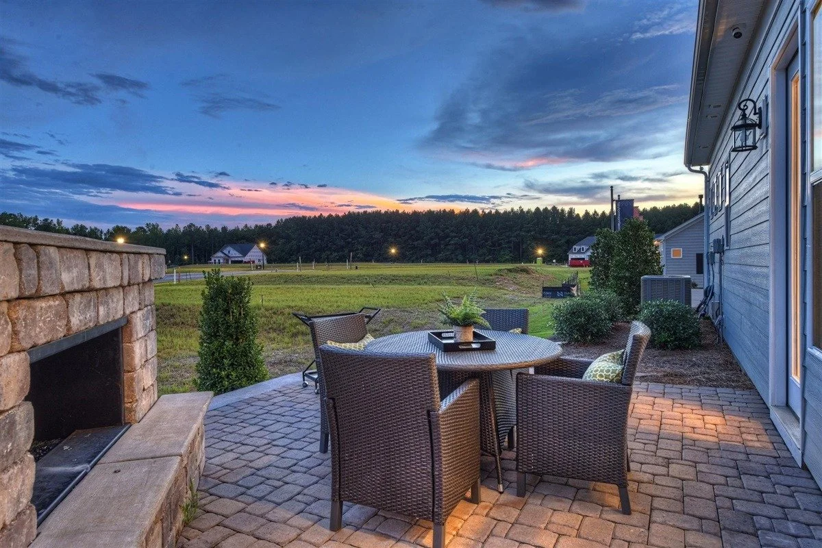 pinnacle-at-wesley-chapel-backyard-patio-with-outdoor-fireplace-at-sunset-active-adult-community-wesley-chapel-nc.jpg