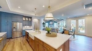 the-courtyards-at-lake-davidson-white-kitchen-with-large-island-and-blue-cabinets-active-adult-community-davidson-nc.jpg