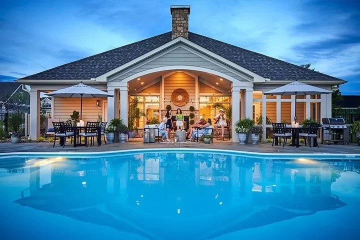 the-courtyards-at-lake-davidson-clubhouse-exterior-with-community-pool-at-dusk-active-adult-community-davidson-nc.jpg
