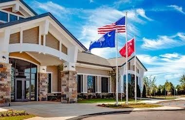 courtyards-of-marvin-clubhouse-exterior-with-flags-and-stone-columns-active-adult-community-marvin-nc.jpg