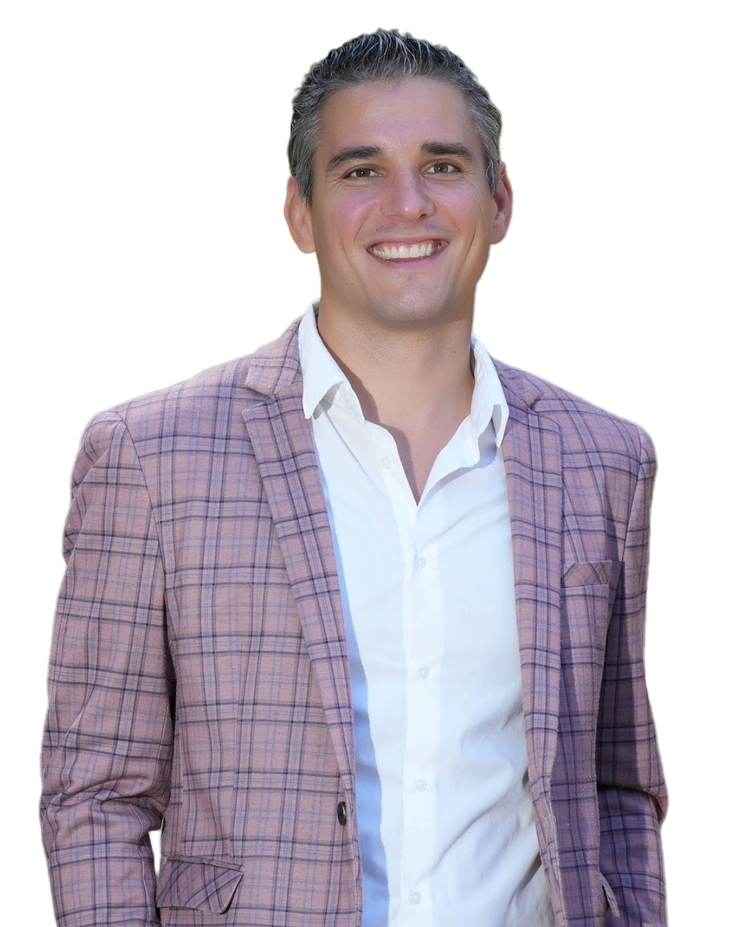 A man smiling, wearing a pink checked blazer over a white shirt, with dark and gray hair.