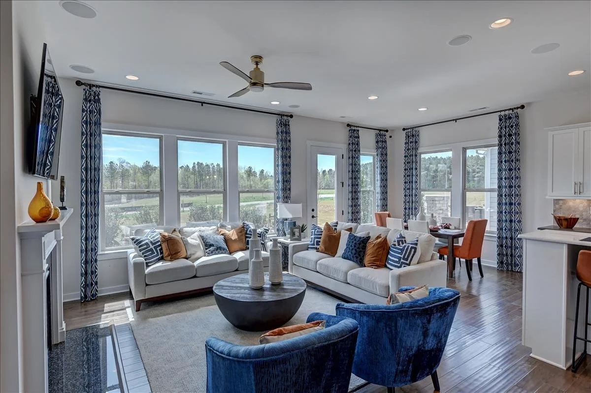 pinnacle-at-wesley-chapel-living-room-with-blue-chairs-and-open-kitchen-active-adult-community-wesley-chapel-nc.jpg