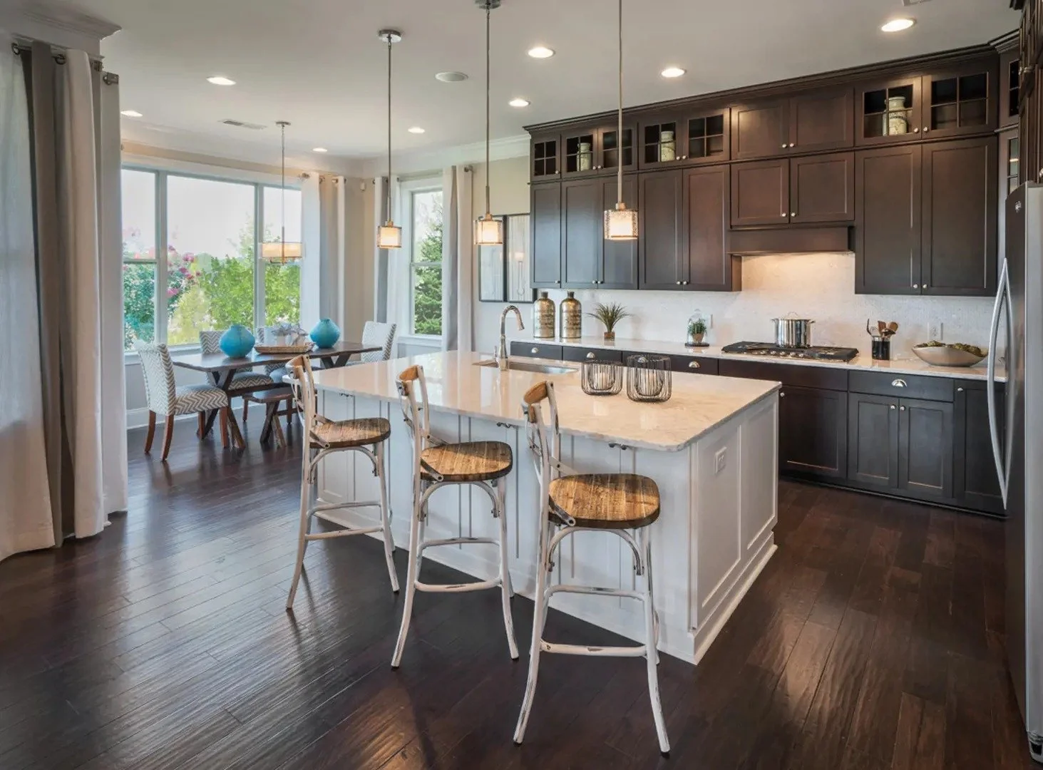 regency-at-palisades-model-home-kitchen-with-dark-island-and-breakfast-area-55-plus-community-charlotte-nc.jpg