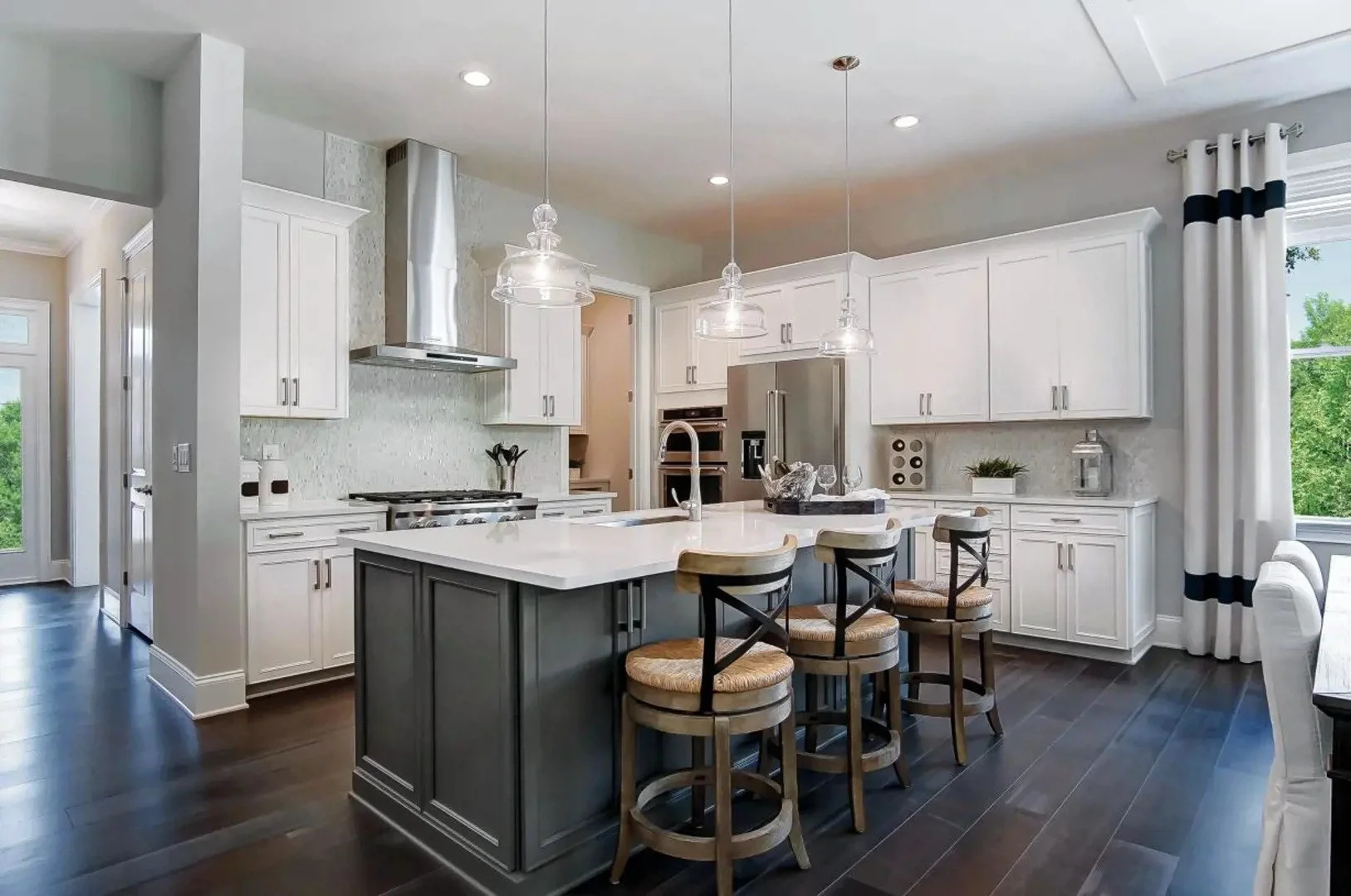 regency-at-palisades-white-kitchen-with-large-island-and-bar-stools-55-plus-community-charlotte-nc.jpg