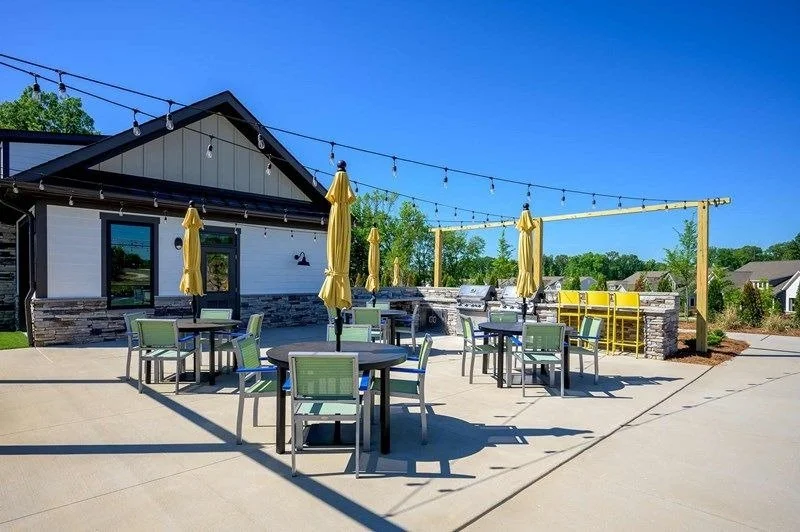encore-at-streamside-outdoor-clubhouse-patio-with-tables-and-string-lights-active-adult-community-waxhaw-nc.jpg