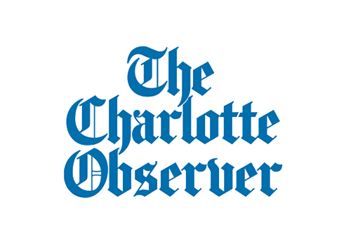Logo of The Charlotte Observer with blue gothic text on a black background.