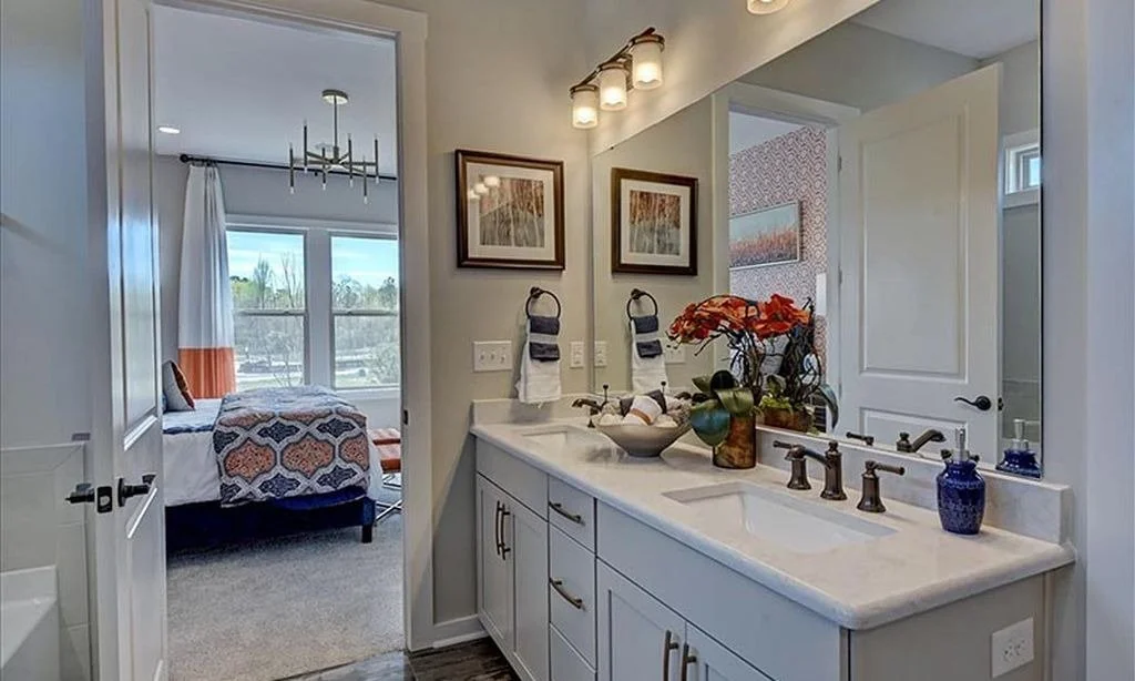 pinnacle-at-wesley-chapel-primary-bathroom-double-vanity-and-bedroom-view-active-adult-community-wesley-chapel-nc.jpg