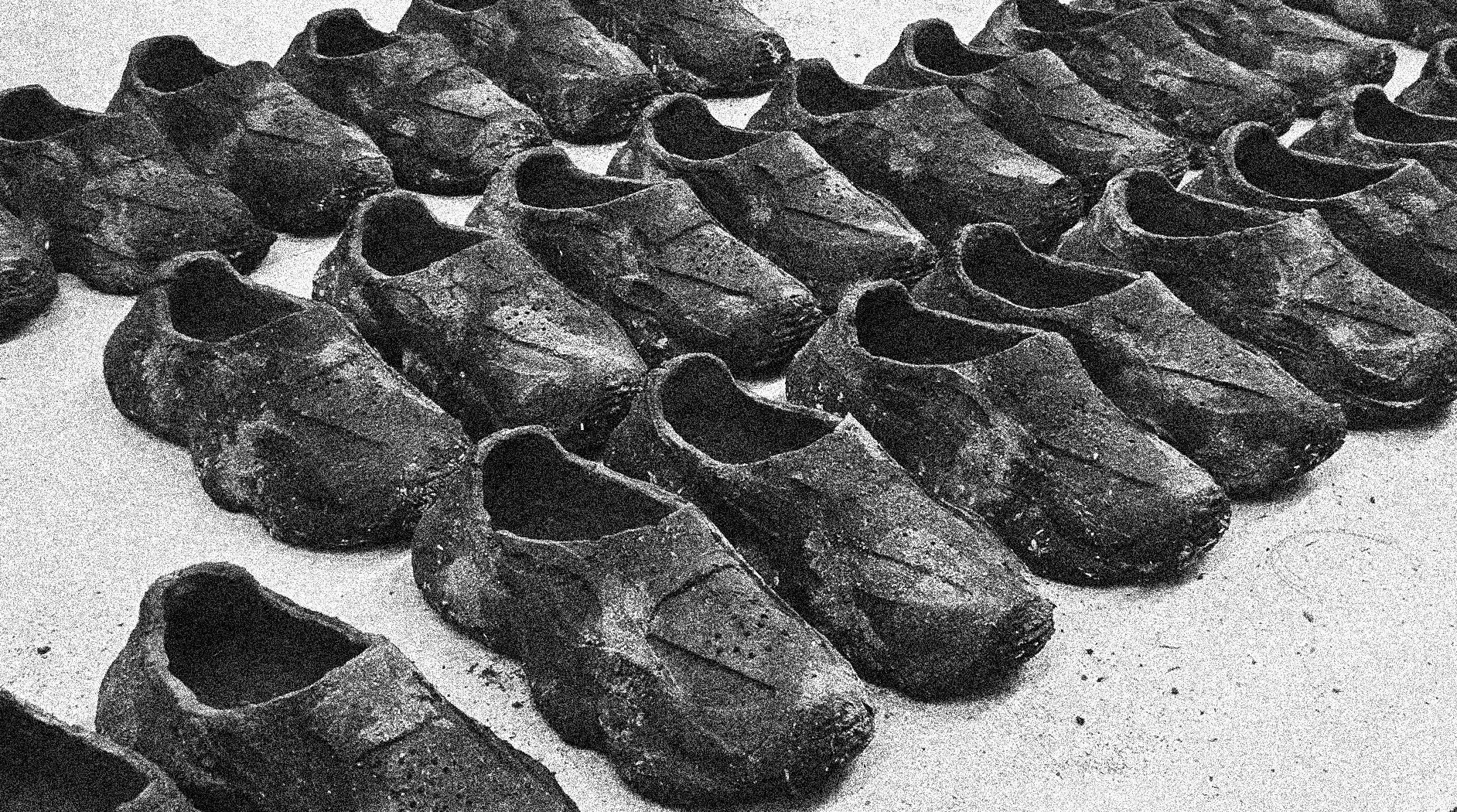 Close-up view of shoes made of a composite soil material arranged in rows on a surface.