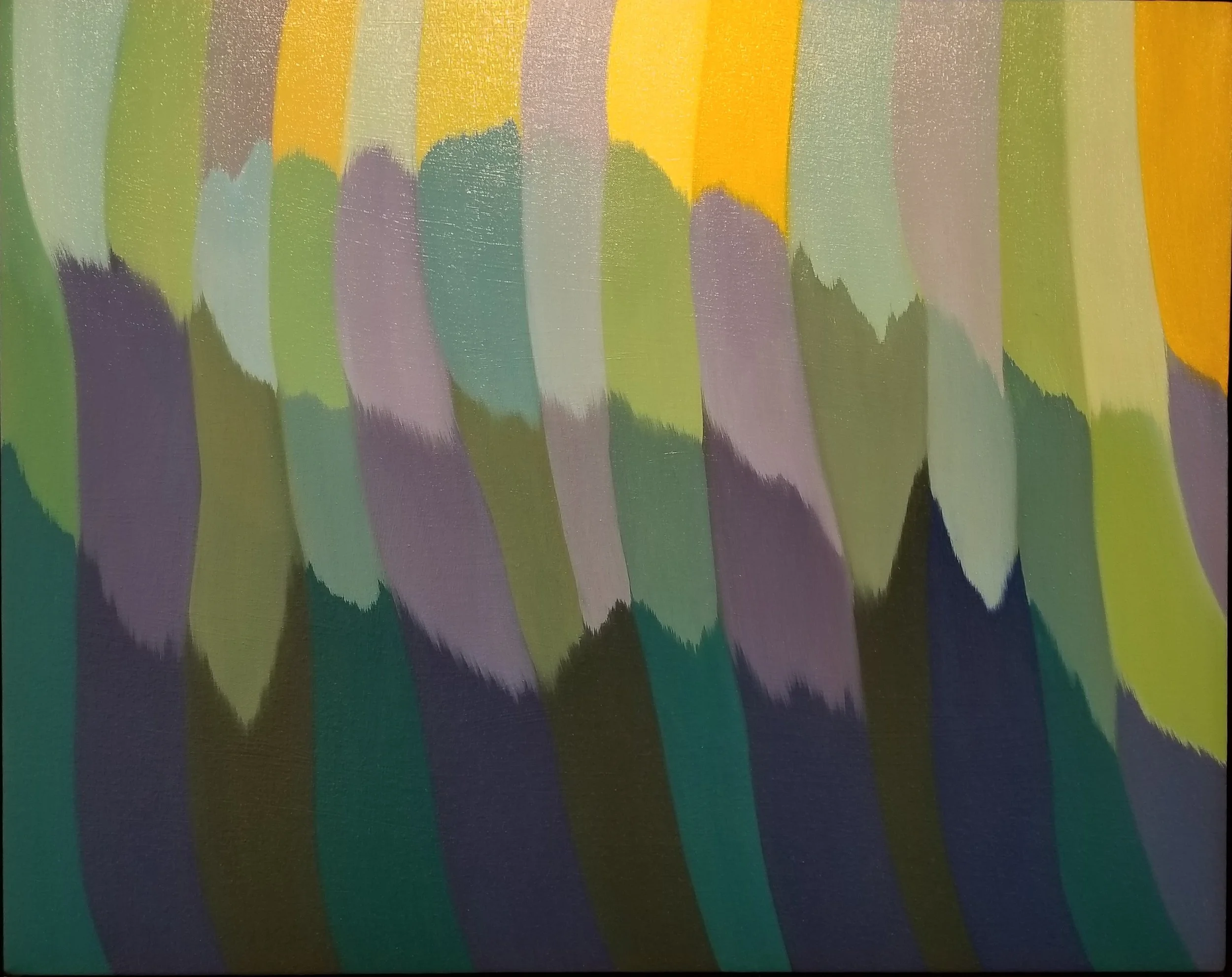 Close-up of a surface with colorful vertical stripes: green, purple, blue, yellow, and orange, with slight texture and glossy finish.