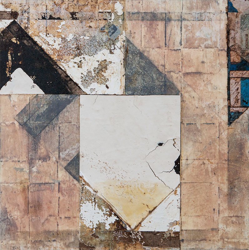 Close-up of dirty, cracked, and peeling tiled floor with a mix of beige, white, black, gray, and blue tiles.